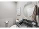 Stylish powder room features a round mirror, dark countertop, and a playful 'Bathroom Rules' sign at 1320 Blue Heron Dr, Nashville, NC 27856