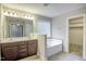 Bathroom with double vanity, soaking tub, and walk in closet at 1354 Red Bud Ct, Wake Forest, NC 27587