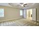Spacious bedroom with a tray ceiling and ensuite bathroom at 1354 Red Bud Ct, Wake Forest, NC 27587