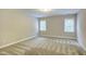 Spacious bedroom with neutral carpet and two windows at 1354 Red Bud Ct, Wake Forest, NC 27587