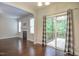 Dining area with hardwood floors and sliding glass doors and view into the living room at 1354 Red Bud Ct, Wake Forest, NC 27587