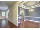 Open concept dining room with hardwood floors, modern chandelier, and easy access to the kitchen at 1354 Red Bud Ct, Wake Forest, NC 27587