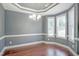 Elegant dining room with hardwood floors, decorative ceiling, and natural light streaming through the windows at 1354 Red Bud Ct, Wake Forest, NC 27587