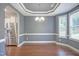 Spacious dining room featuring a tray ceiling, dark hardwood floors, and large windows for ample natural light at 1354 Red Bud Ct, Wake Forest, NC 27587