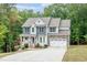 Charming two-story home with stone accents, a welcoming porch, and an attached two-car garage at 1354 Red Bud Ct, Wake Forest, NC 27587