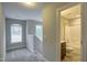 Hallway with view of staircase and adjacent bathroom with tile surround tub at 1354 Red Bud Ct, Wake Forest, NC 27587