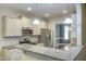 Modern kitchen featuring stainless steel appliances, granite countertops, and white cabinetry at 1354 Red Bud Ct, Wake Forest, NC 27587
