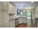 Bright kitchen features stainless steel appliances, granite countertops, and white cabinetry at 1354 Red Bud Ct, Wake Forest, NC 27587