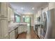 Bright kitchen features stainless steel appliances, granite countertops, and white cabinetry at 1354 Red Bud Ct, Wake Forest, NC 27587