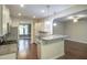 Open kitchen featuring stainless steel appliances, granite countertops, and white cabinets at 1354 Red Bud Ct, Wake Forest, NC 27587