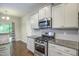 The kitchen has stainless steel appliances, a gas range, and granite countertops at 1354 Red Bud Ct, Wake Forest, NC 27587