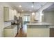 Modern kitchen with stainless steel appliances, granite countertops, and white cabinets at 1354 Red Bud Ct, Wake Forest, NC 27587