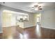 Open-concept living area with hardwood floors, leading to a modern kitchen and other rooms at 1354 Red Bud Ct, Wake Forest, NC 27587