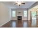 Bright living room featuring a fireplace, ceiling fan, and access to an outdoor deck at 1354 Red Bud Ct, Wake Forest, NC 27587
