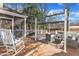 Spacious wooden back deck with comfortable seating, pergola, and a view of the backyard at 14 Wedgewood Pl, Clayton, NC 27527