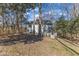 Large backyard with trees shading the two-story home featuring a covered porch and picket fence at 14 Wedgewood Pl, Clayton, NC 27527