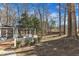 Scenic backyard featuring a wooden deck, pergola, and spacious lawn surrounded by trees at 14 Wedgewood Pl, Clayton, NC 27527