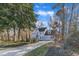 Large two-story house with a two-car garage, long driveway, and mature trees at 14 Wedgewood Pl, Clayton, NC 27527