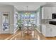 Charming kitchen nook with a white table set beside large windows and classic decor at 14 Wedgewood Pl, Clayton, NC 27527