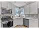 Bright kitchen area boasts stainless steel appliances, granite countertops, and natural light at 14 Wedgewood Pl, Clayton, NC 27527