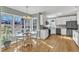 Bright eat-in kitchen with white cabinetry, stainless appliances, and sun-drenched breakfast nook at 14 Wedgewood Pl, Clayton, NC 27527