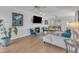 Bright living room with a fireplace, hardwood floors, and comfortable seating area at 14 Wedgewood Pl, Clayton, NC 27527