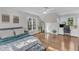 Sunlit main bedroom with hardwood floors, a ceiling fan, and a window view at 14 Wedgewood Pl, Clayton, NC 27527
