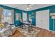 Home office with built-in desk, natural light, and a comfortable seating area at 14 Wedgewood Pl, Clayton, NC 27527