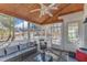 Cozy screened porch features wicker furniture, a ceiling fan, and a view of the backyard at 14 Wedgewood Pl, Clayton, NC 27527