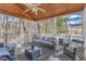 Inviting screened porch with wicker furniture, ceiling fan, and patterned outdoor rug at 14 Wedgewood Pl, Clayton, NC 27527