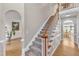 Carpeted staircase with wooden handrail leading to the upper level of the home at 14 Wedgewood Pl, Clayton, NC 27527