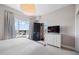 Bright bedroom featuring stylish wallpaper, a light fixture, and outside views from the window at 140 W Franklin St # 406, Chapel Hill, NC 27516