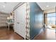 Hallway featuring hardwood floors, patterned wallpaper, with access to the bathroom and bedroom at 140 W Franklin St # 406, Chapel Hill, NC 27516