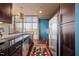 Modern kitchen with stainless steel appliances, dark cabinetry, granite countertops, and bright natural light at 140 W Franklin St # 406, Chapel Hill, NC 27516