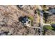 An aerial view of the home and its surrounding landscaped lot, with a long driveway, in a residential area at 155 Georgetown Woods Dr, Youngsville, NC 27596