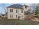 Spacious backyard featuring the home's exterior, a deck, patio, and lush greenery for outdoor enjoyment at 155 Georgetown Woods Dr, Youngsville, NC 27596