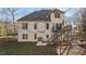 Expansive backyard showcases the home's exterior with a deck, patio, and lush greenery for outdoor enjoyment at 155 Georgetown Woods Dr, Youngsville, NC 27596