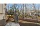 Spacious backyard features a deck, patio, fire pit, and mature trees offering space for relaxation at 155 Georgetown Woods Dr, Youngsville, NC 27596