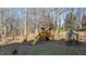 Fenced backyard featuring a wooden playset, swing and covered area for outdoor enjoyment at 155 Georgetown Woods Dr, Youngsville, NC 27596