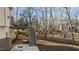 Backyard featuring a deck, staircase, and fire pit area at 155 Georgetown Woods Dr, Youngsville, NC 27596