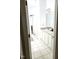 Bright bathroom featuring tile flooring, granite countertops, and abundant cabinet space at 155 Georgetown Woods Dr, Youngsville, NC 27596