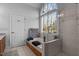 Luxurious bathroom with soaking tub, walk-in shower, and large window with view at 155 Georgetown Woods Dr, Youngsville, NC 27596