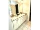 Bathroom featuring double sinks, granite countertops, and ample cabinet space at 155 Georgetown Woods Dr, Youngsville, NC 27596