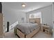 Neutral bedroom with a light wood bed frame and bright natural light at 155 Georgetown Woods Dr, Youngsville, NC 27596