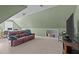 Large bonus room with a leather couch and a television at 155 Georgetown Woods Dr, Youngsville, NC 27596