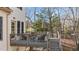 A relaxing outdoor deck features seating, an umbrella, and provides space to enjoy the surrounding nature at 155 Georgetown Woods Dr, Youngsville, NC 27596