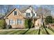 Beautiful brick house with detailed trim, surrounded by lush landscaping and an attractive, well-maintained front lawn at 155 Georgetown Woods Dr, Youngsville, NC 27596