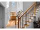 Spacious foyer featuring wood and carpeted stairs and a beautiful glass front door at 155 Georgetown Woods Dr, Youngsville, NC 27596