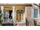 Charming front door with decorative glass and inviting entryway with hanging basket at 155 Georgetown Woods Dr, Youngsville, NC 27596