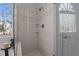Tiled shower with glass door, rainfall shower head, and built-in shelving at 155 Georgetown Woods Dr, Youngsville, NC 27596